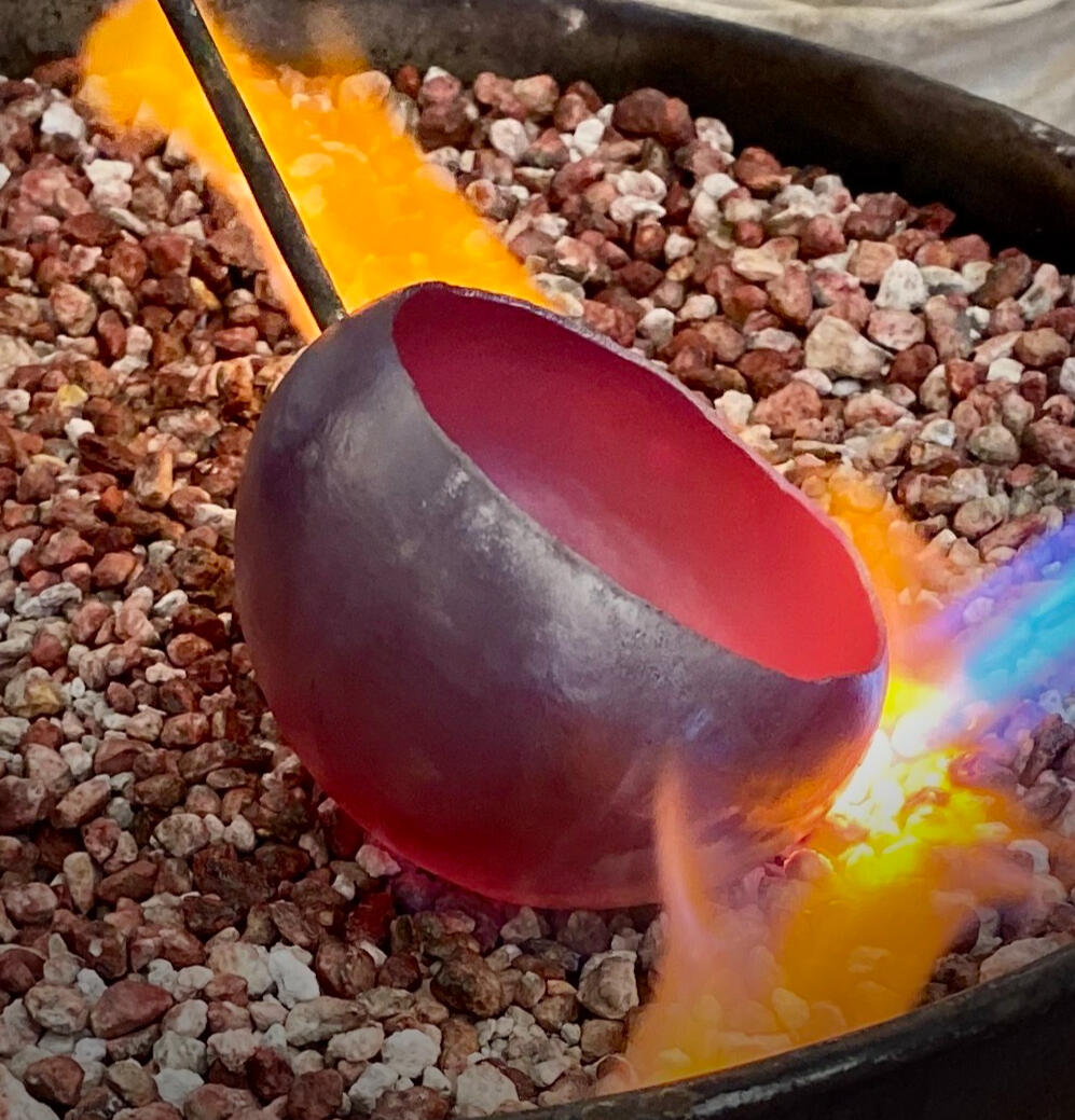 torch heating copper vessel to red heat
